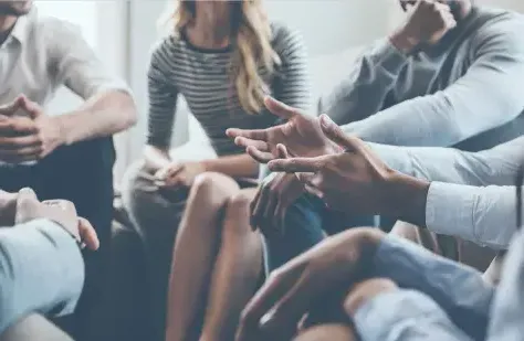 A group of people sitting in a circle 